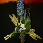 Pour un hommage à Dyonisos ou Bacchus,un étonnant bouquet triangulaire, construit avec Delphiniums bleus, Eremurus et arums plantés en masses bien distinctes. 