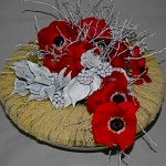 Anémones, renoncules rouges, couronne recouverte de neige et jeu de branches de myrtillier peint.