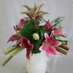 Des lys et un ananas  composent avec la rhubarbe un bouquet coloré de  fleurs et fruits.